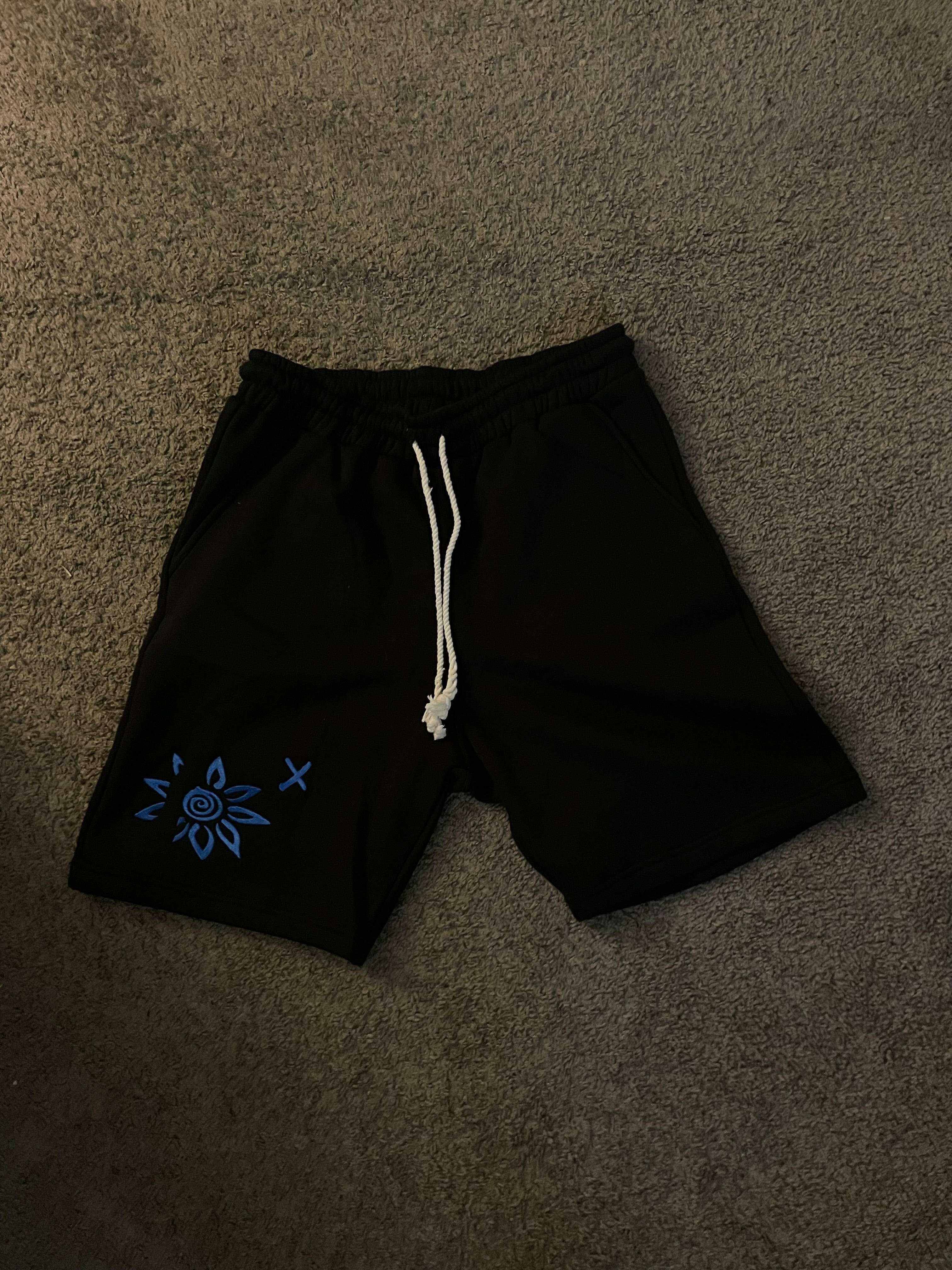 Black shorts with blue embroidered WISE FLOWER X design and white beach rope drawstring