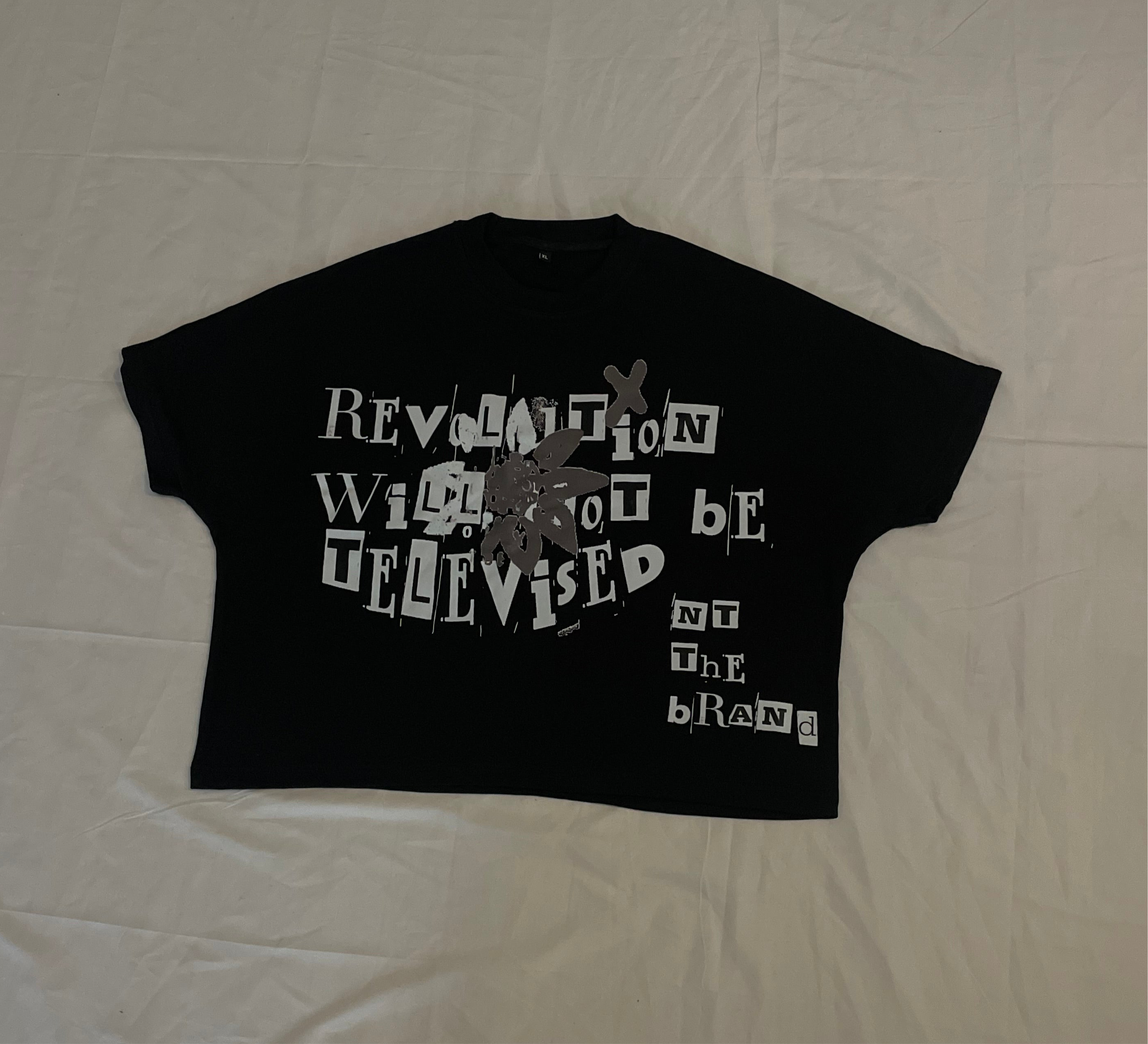 Black silver RWNBT box T-shirt with crewneck and front screen printed logo saying "Revolution will not be televised"