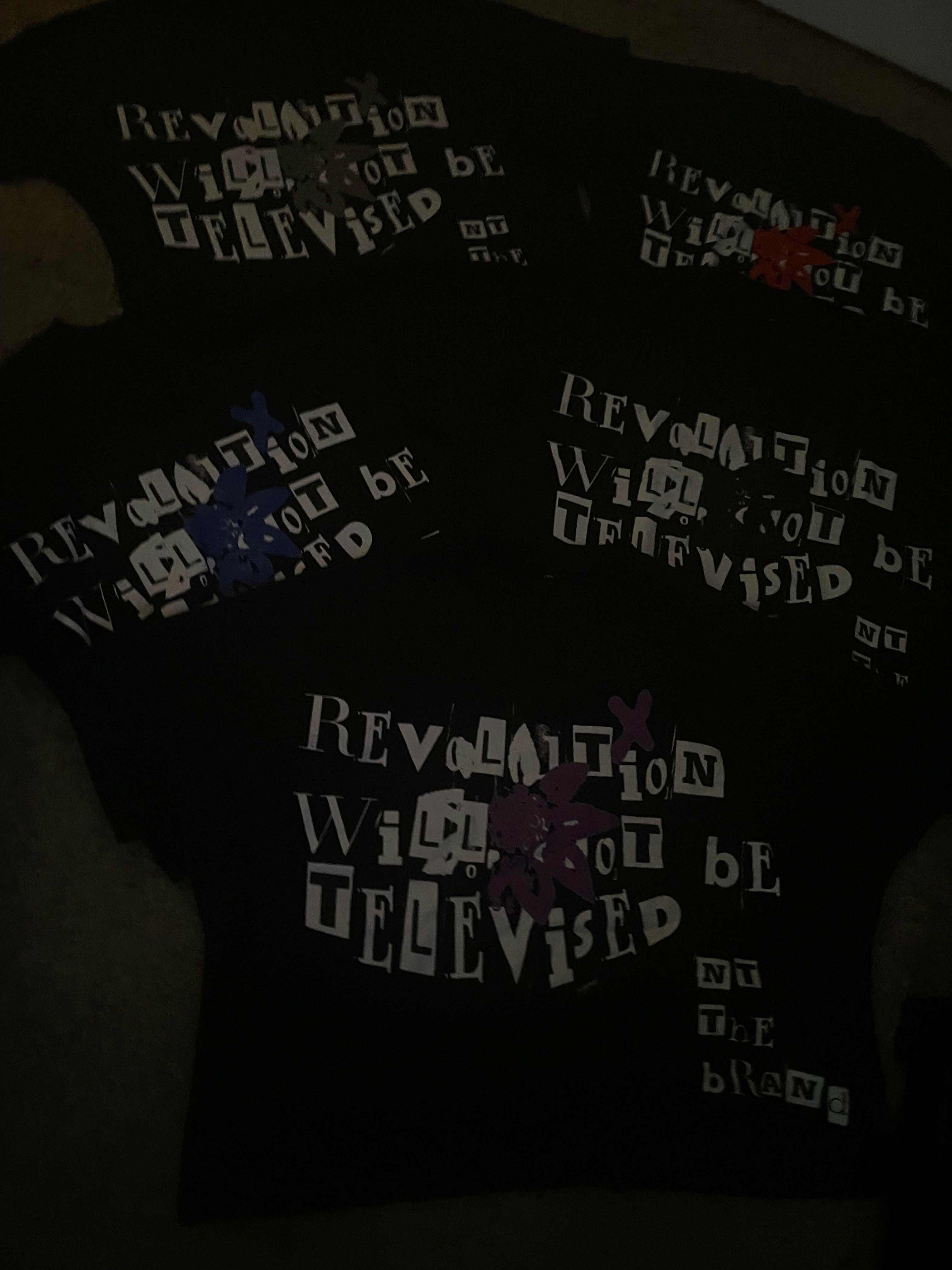 Set of black Revolution bundle T-shirts with "Revolution will not be televised" text and colorful flower x symbols on each shirt
