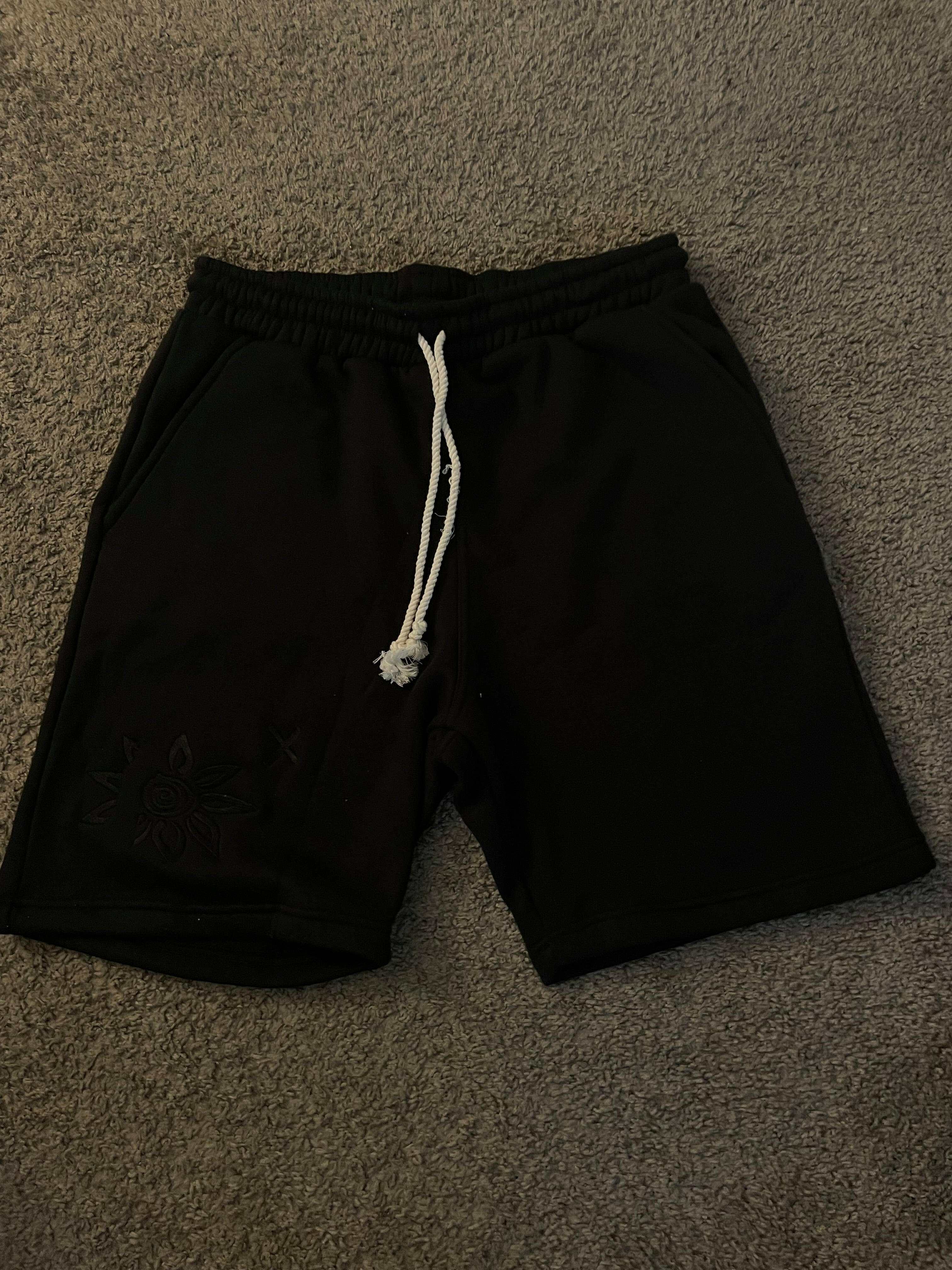 Black on black Wise Flower X men's shorts with embroidered cotton flower logo and white triple braided rope waist string