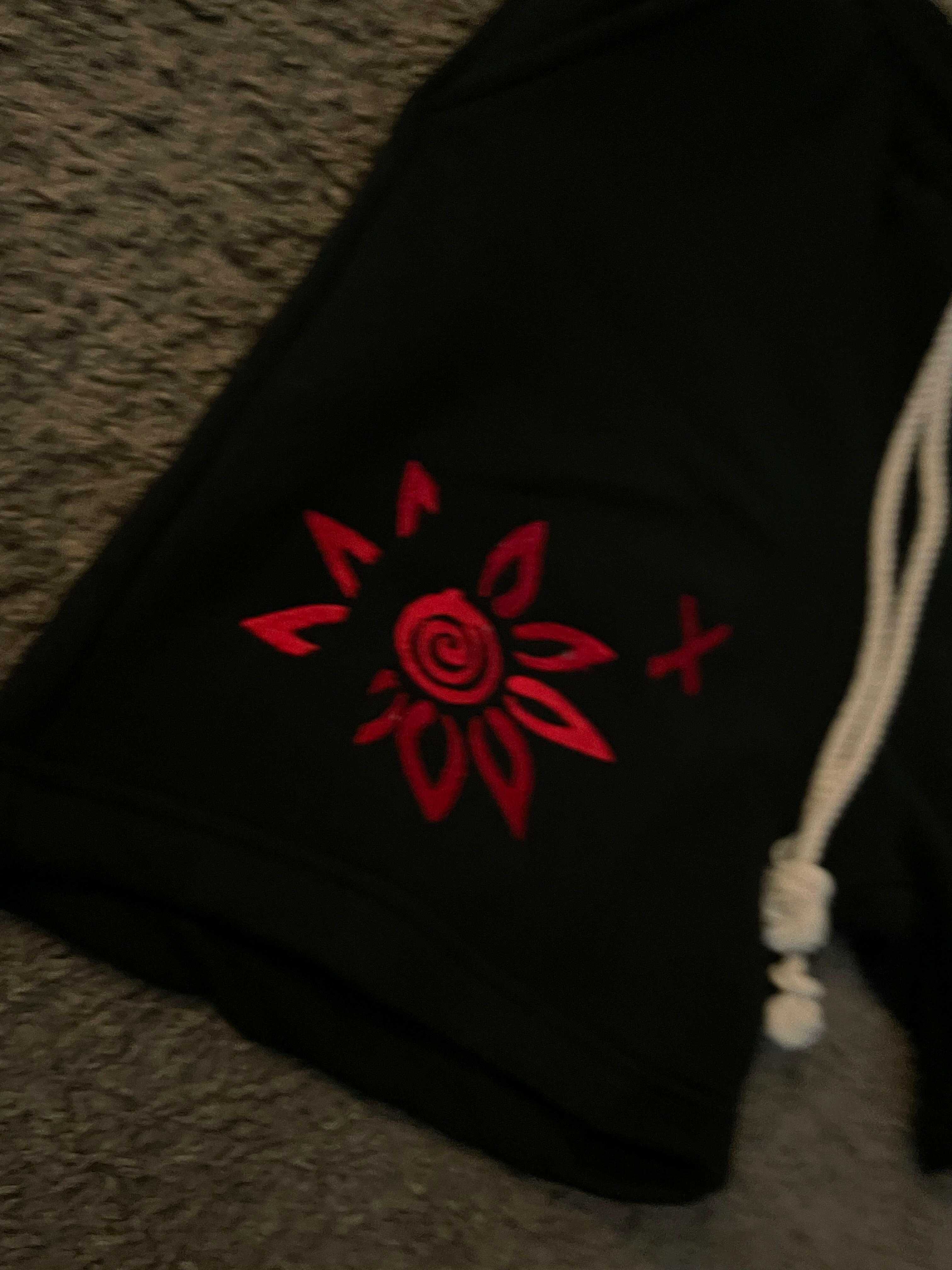 Black shorts with red embroidered WISE Flower x design and white drawstring