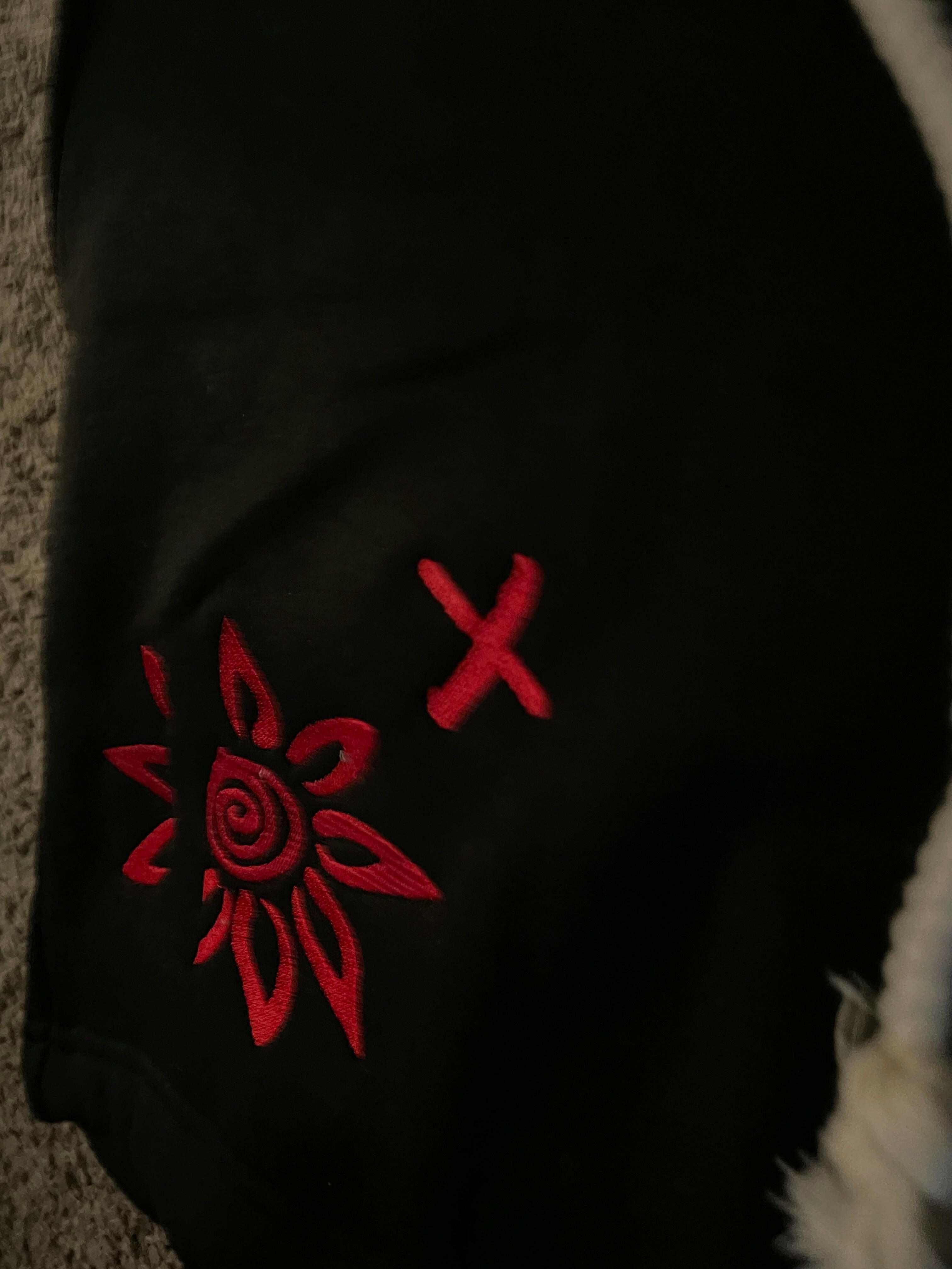 Black shorts with red embroidered WISE Flower x design