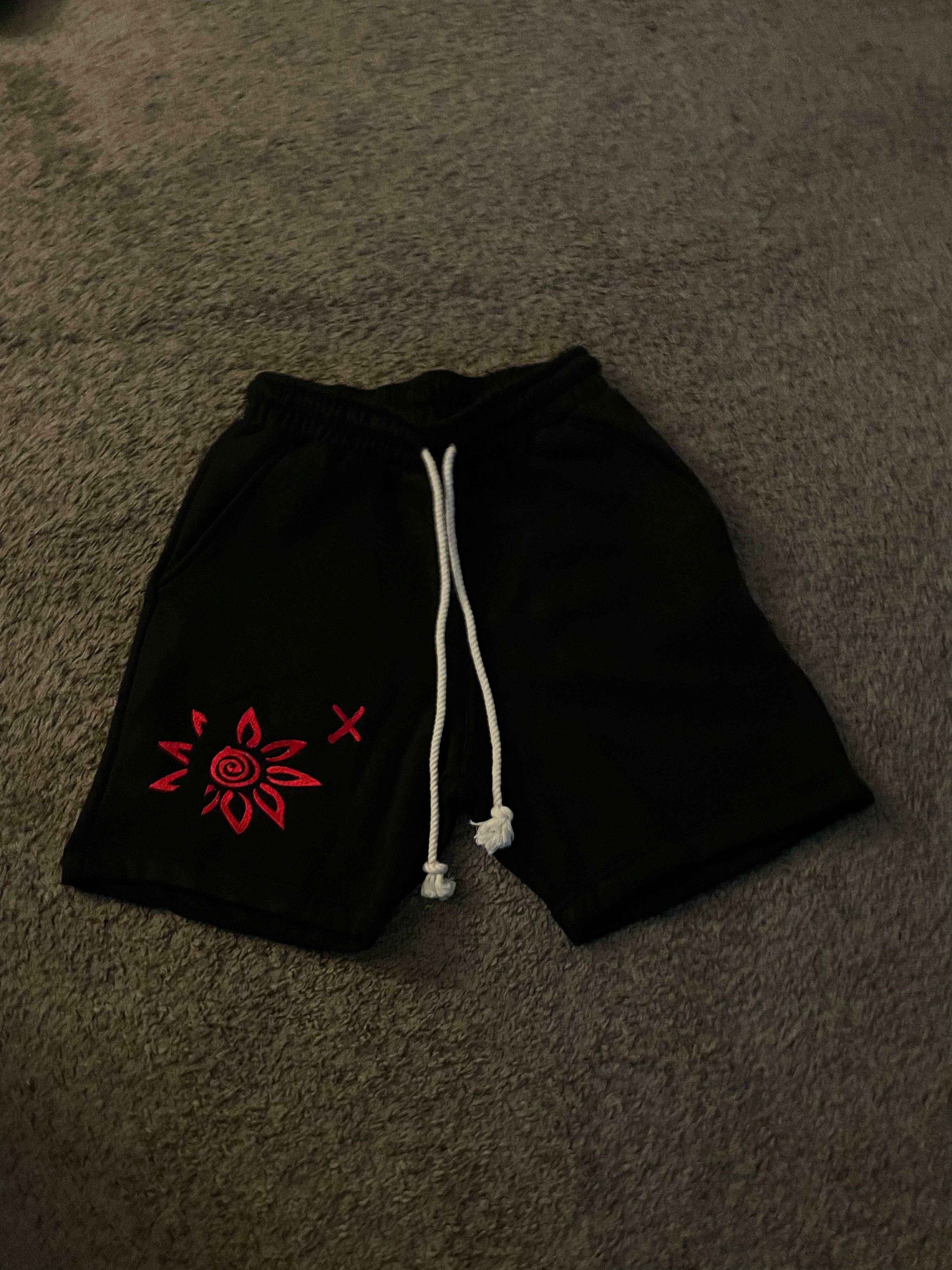 Black shorts with red embroidered WISE Flower x design and white drawstring