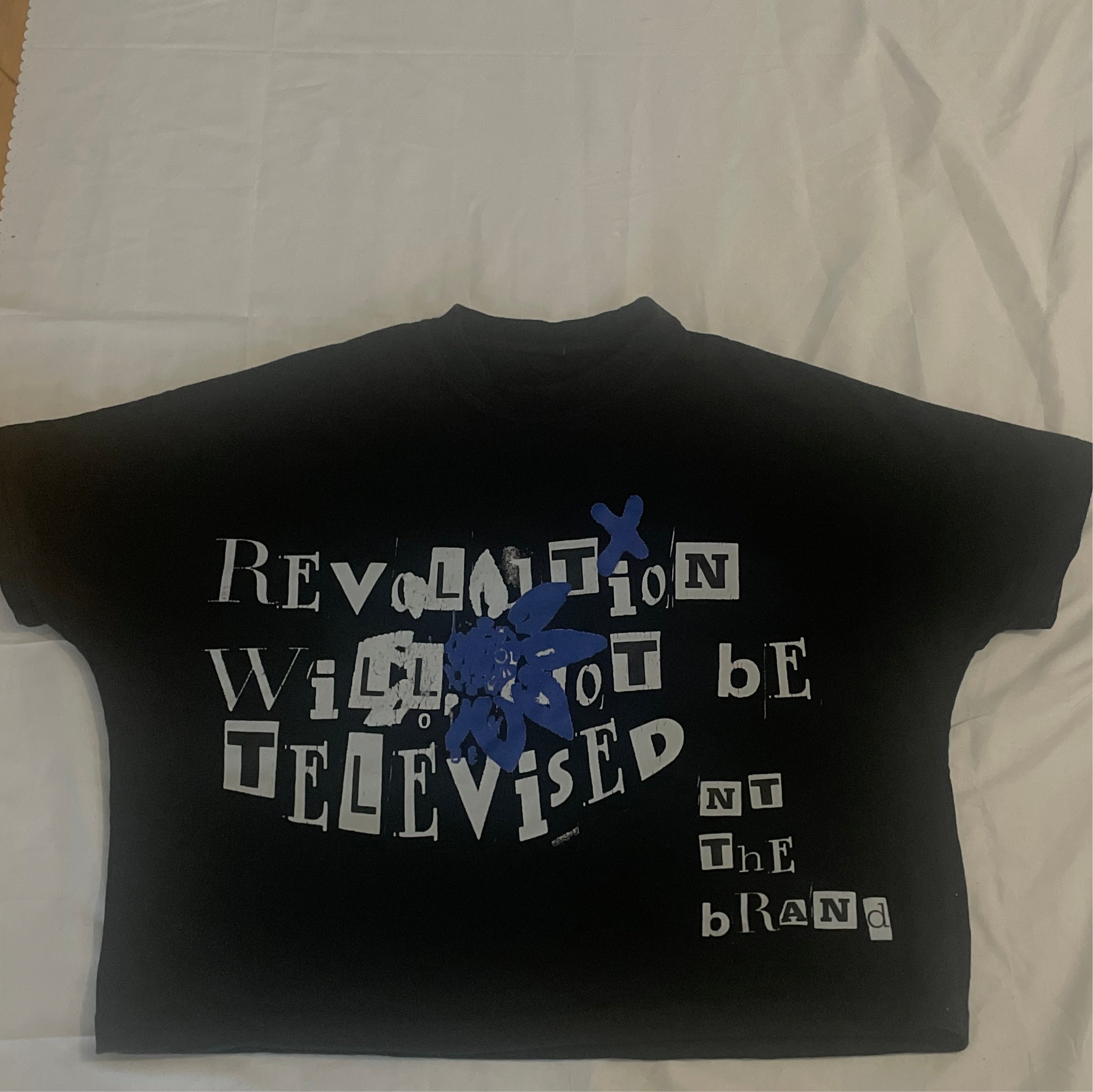  RWTBT Revolution Blue  box fit T-shirt with front screen printed text and blue flower symbol design