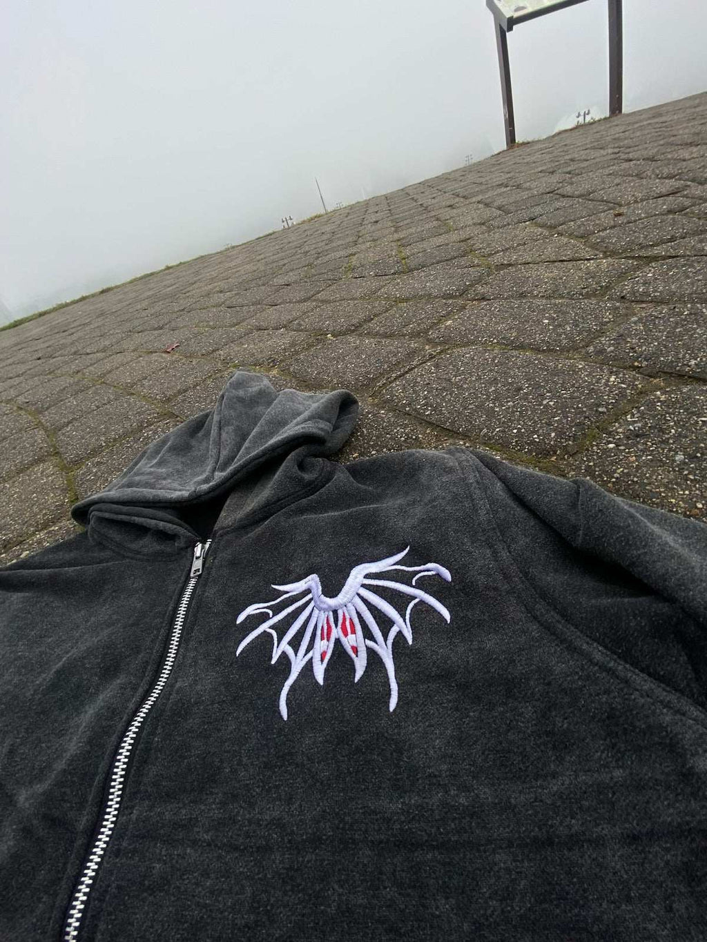 Black RPRT Hoodie Jacket with embroidered white and red design, zip-up front, made of denim terry and cotton blend