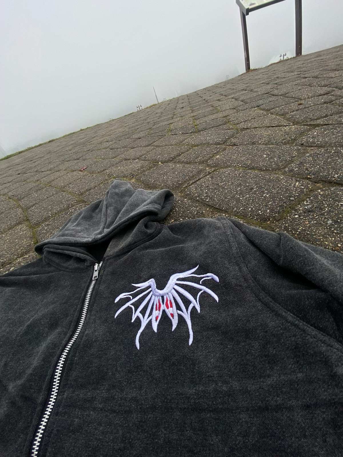 Black RPRT Hoodie Jacket with embroidered white and red design, zip-up front, made of denim terry and cotton blend