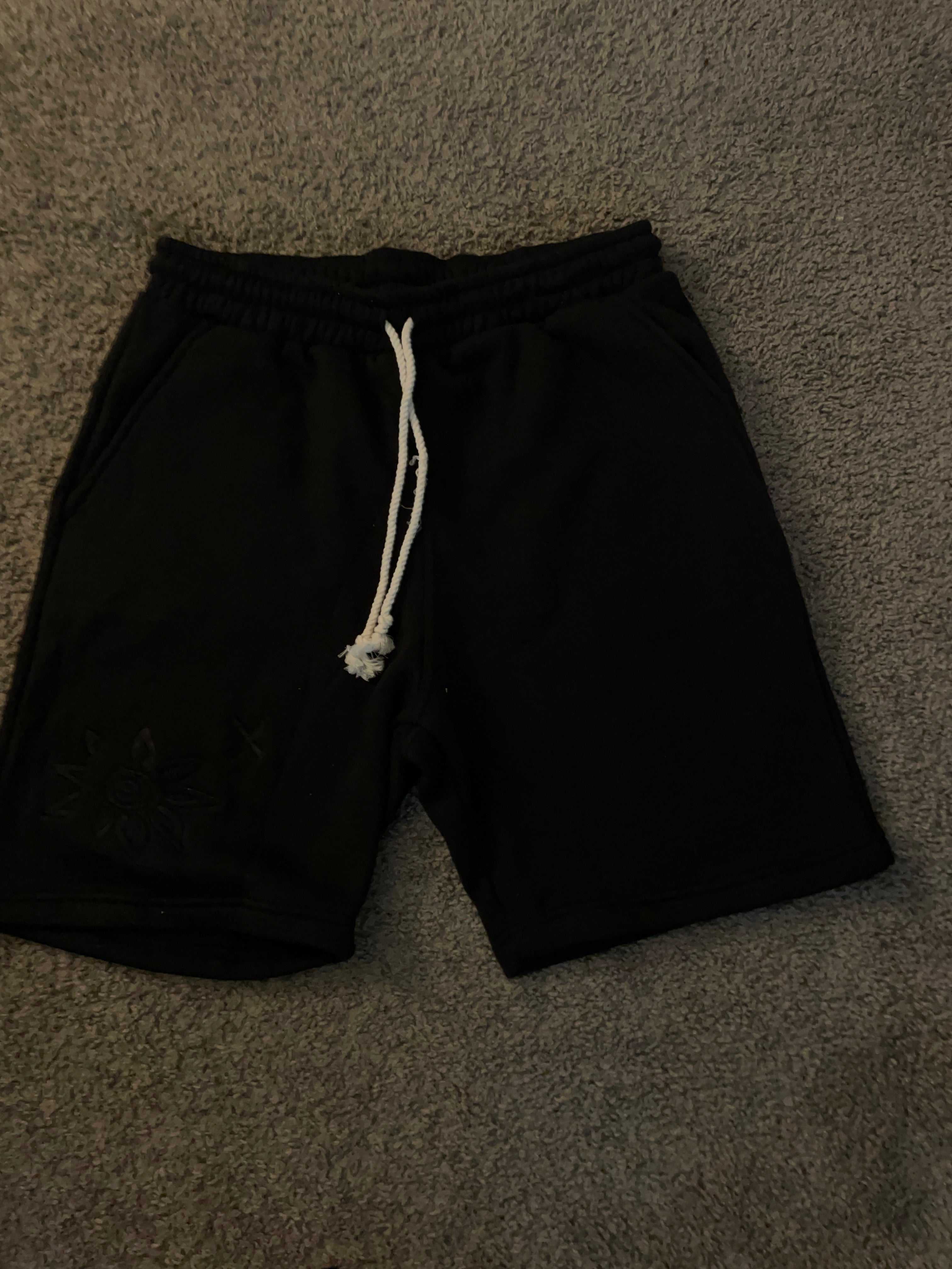 Black Wise Flower X men's shorts with white triple braided rope waist string and embroidered flower X logo