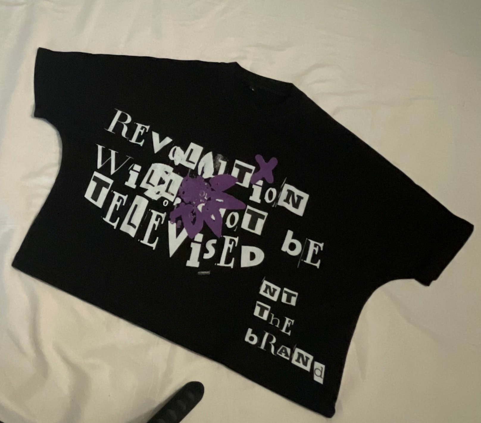 Black RWNBT Box T-shirt with purple flower symbol and white text, box fit style, 100% cotton, front screen printed logo.