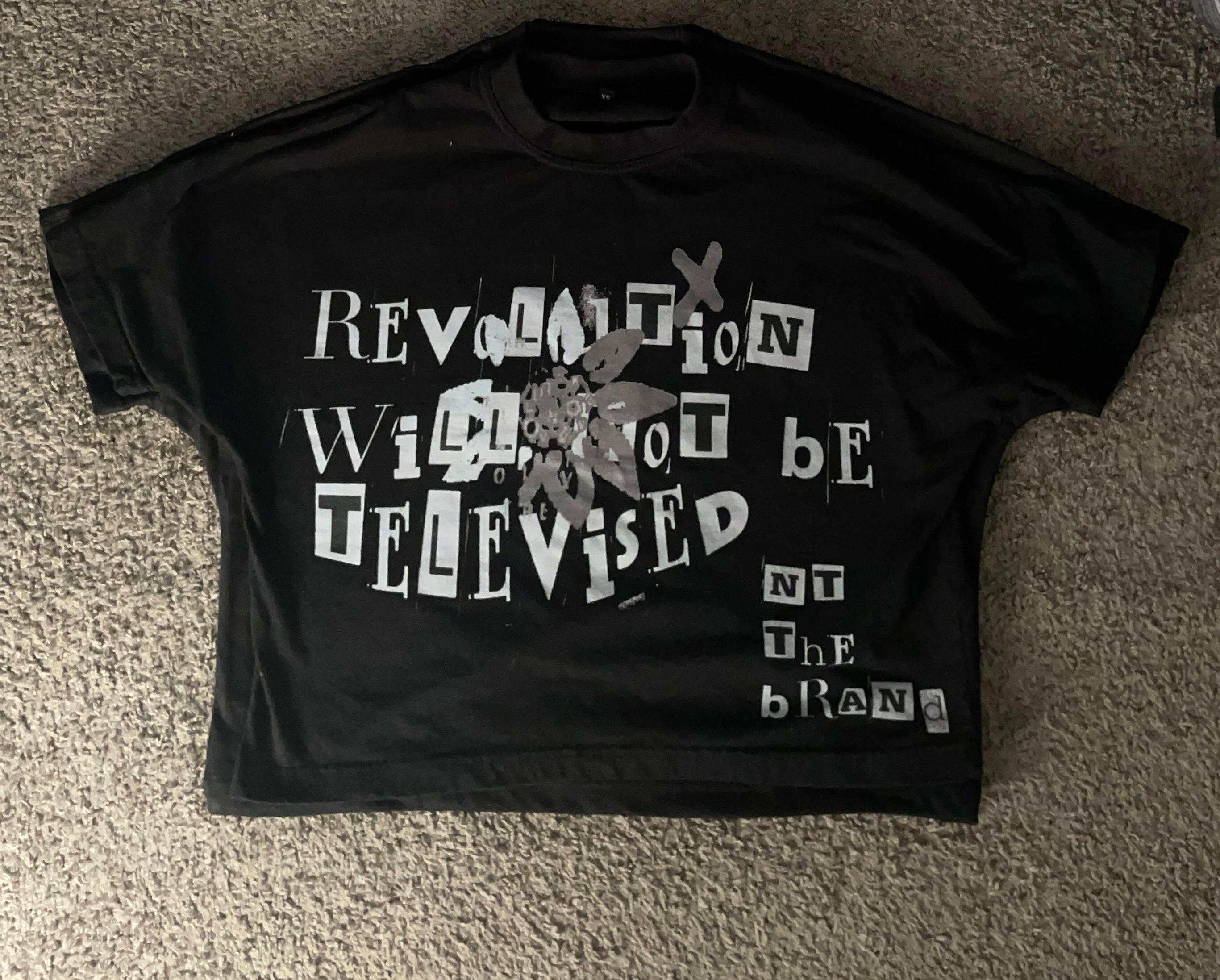 Black box fit RWNBT shirt with silver flower and "Revolution Will Not Be Televised" screen printed crewneck design.